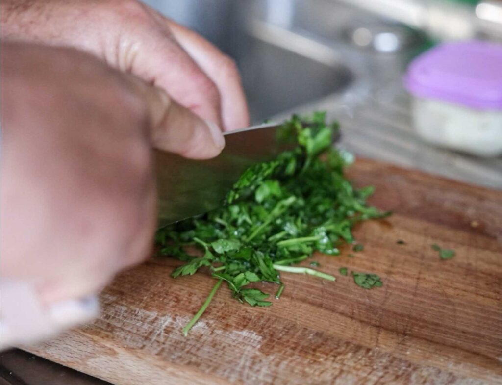 chopping up flat leaf parsley